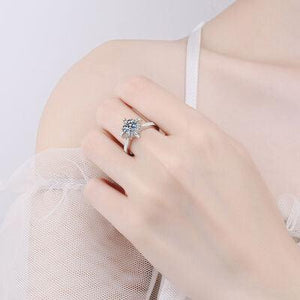 a woman wearing a ring with a flower on it