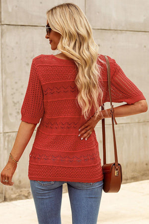 a woman wearing a red sweater and jeans