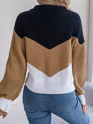 a woman wearing a sweater and jeans