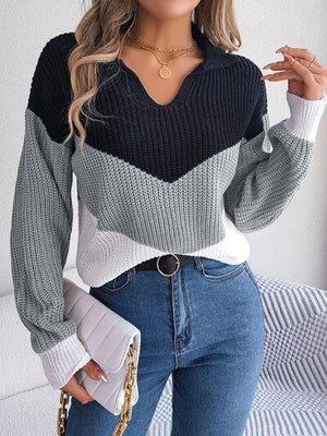 a woman wearing a sweater and jeans