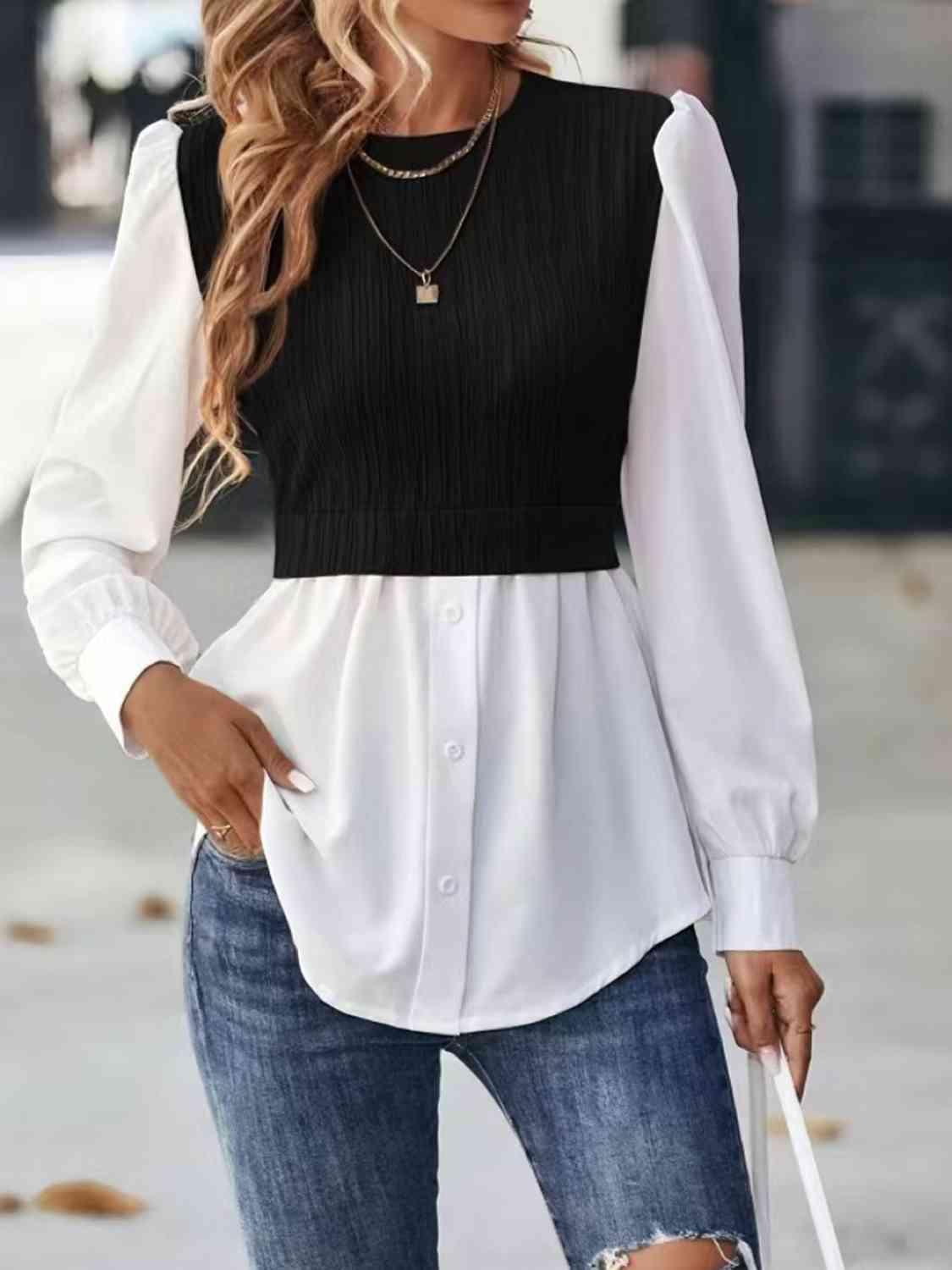 a woman wearing a black and white top and ripped jeans