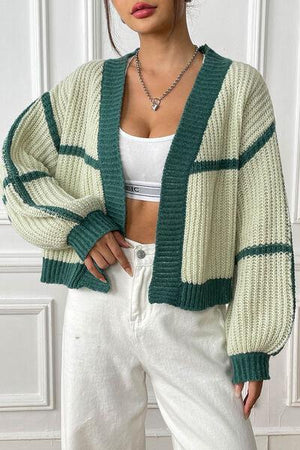 a woman wearing a green and white striped cardigan
