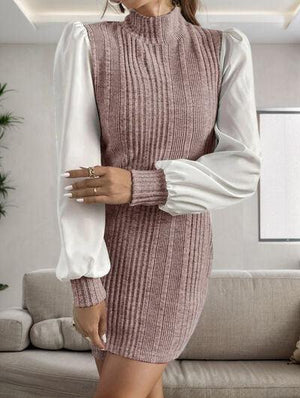 a woman standing in a living room wearing a sweater dress