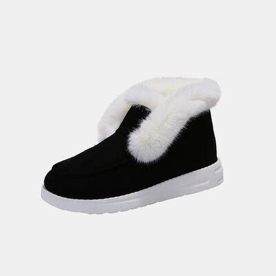 a pair of black slippers with white fur