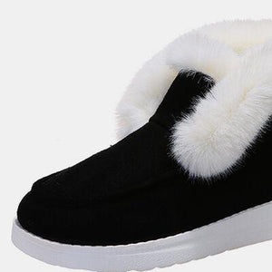 a pair of black and white slippers with fur