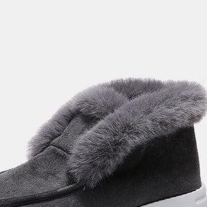 a pair of black slippers with a fur lined top