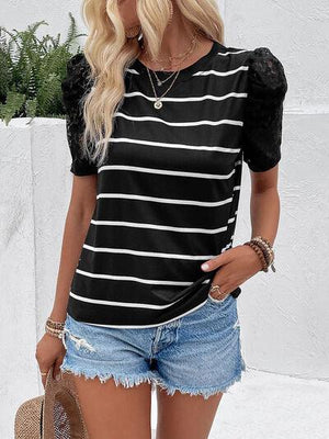a woman wearing a black and white striped top