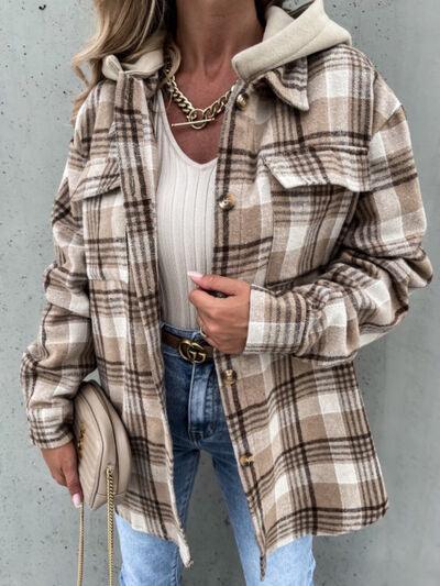 a woman wearing a plaid coat and jeans