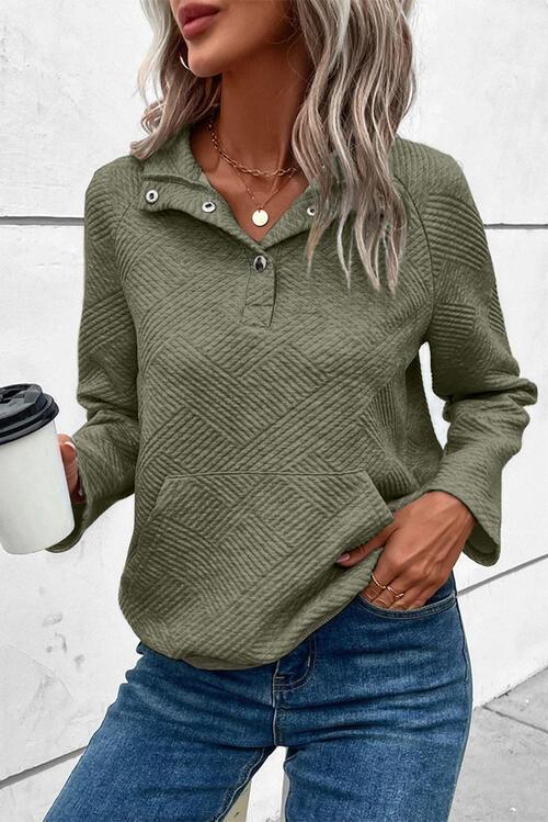 a woman wearing a green sweater and jeans