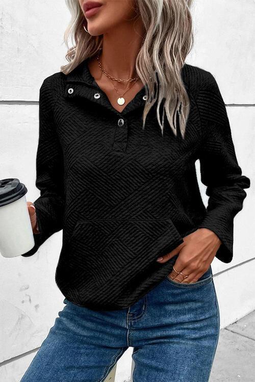 a woman wearing a black sweater and jeans