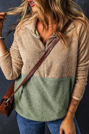 a woman holding a brown purse and wearing a brown hat