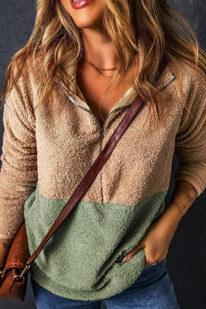 a woman wearing a hat and holding a purse