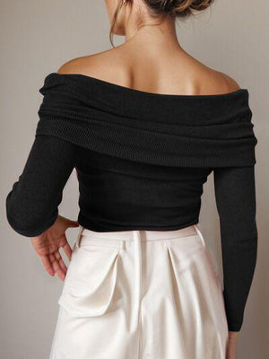 a woman wearing a black top and white pants