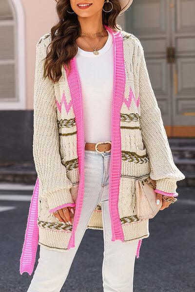 a woman wearing a hat and a cardigan sweater