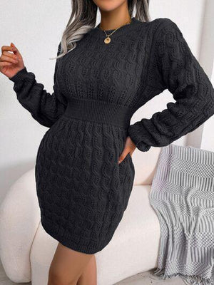 a woman wearing a black cable knit dress