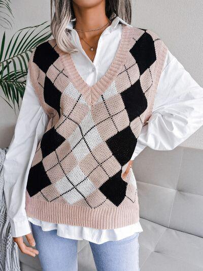 a woman wearing a pink and black sweater vest