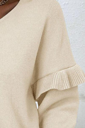 a close up of a woman wearing a beige sweater