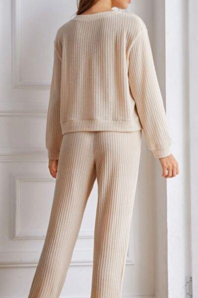 a woman in a beige sweater and pants