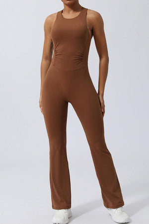 a woman in a brown jumpsuit posing for a picture