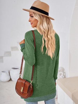 a woman wearing a green sweater and hat
