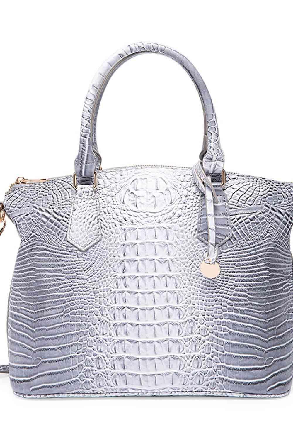 a handbag with a silver alligator skin pattern