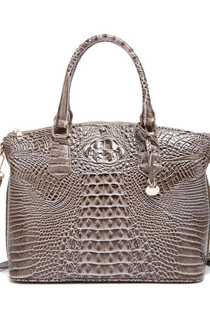 a brown crocodile skin handbag with a handle