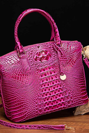 a pink purse sitting on top of a wooden table
