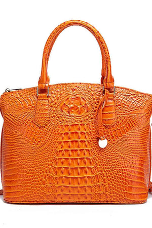 an orange alligator skin handbag on a white background