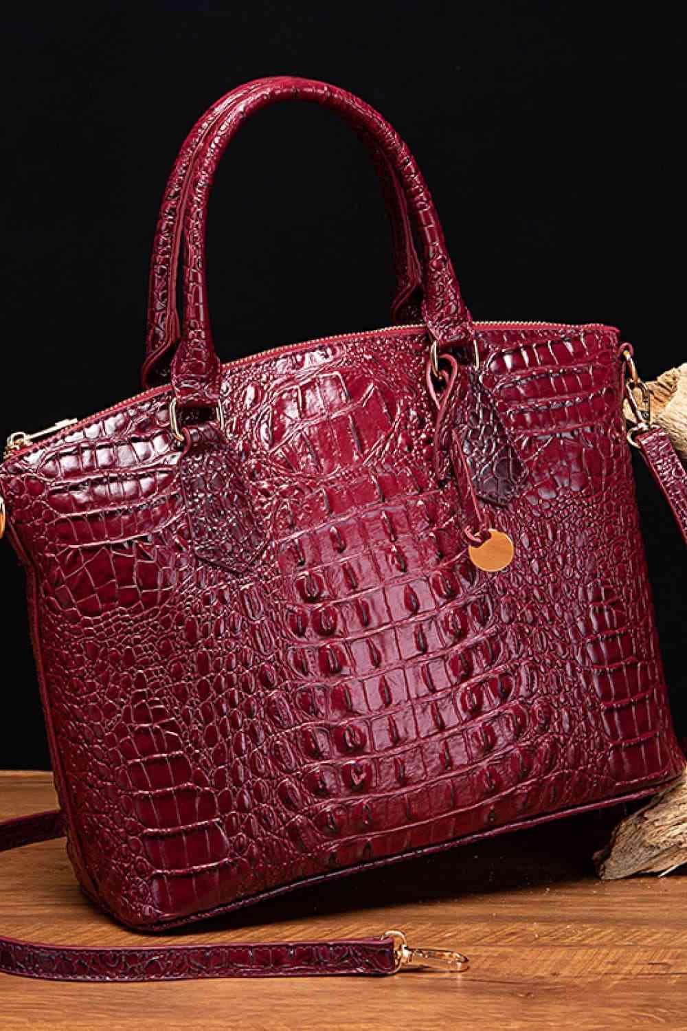 a red purse sitting on top of a wooden table