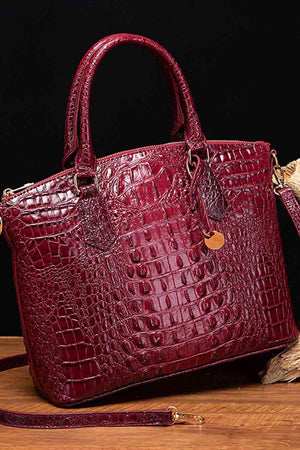 a red purse sitting on top of a wooden table