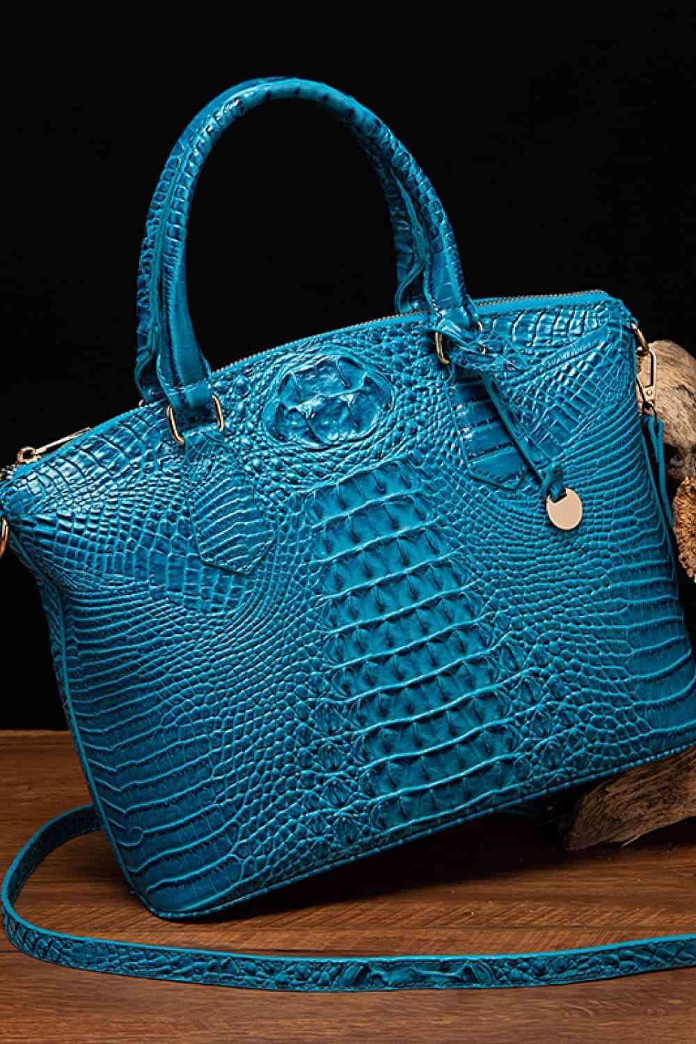 a blue purse sitting on top of a wooden table