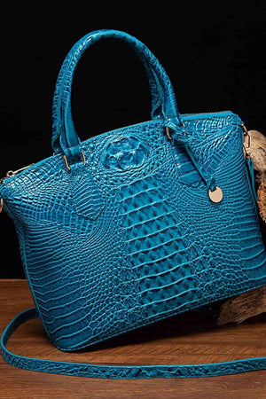 a blue purse sitting on top of a wooden table