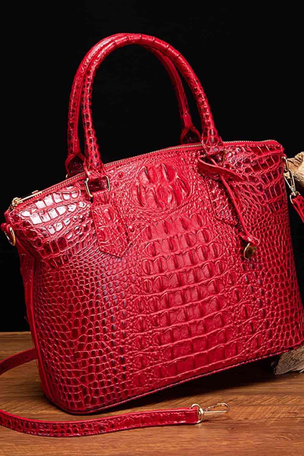 a red purse sitting on top of a wooden table