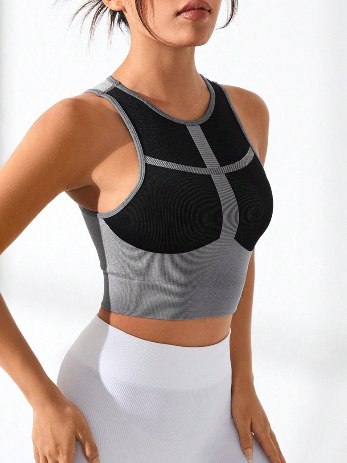 a woman in a gray and black sports bra