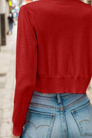 a woman wearing a red sweater and jeans