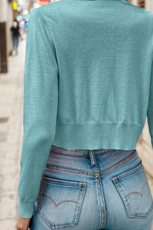 a woman in a blue top is walking down the street