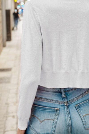 a woman wearing a white shirt and jeans