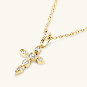 a diamond cross pendant on a gold chain