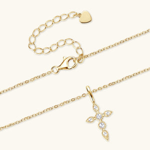 a gold necklace with a cross on it