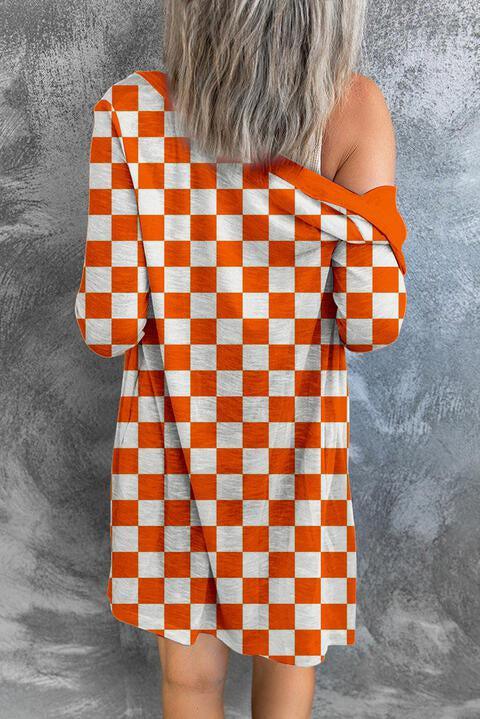a woman wearing an orange and white checkered dress