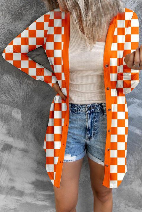 a woman wearing an orange and white checkered cardigan