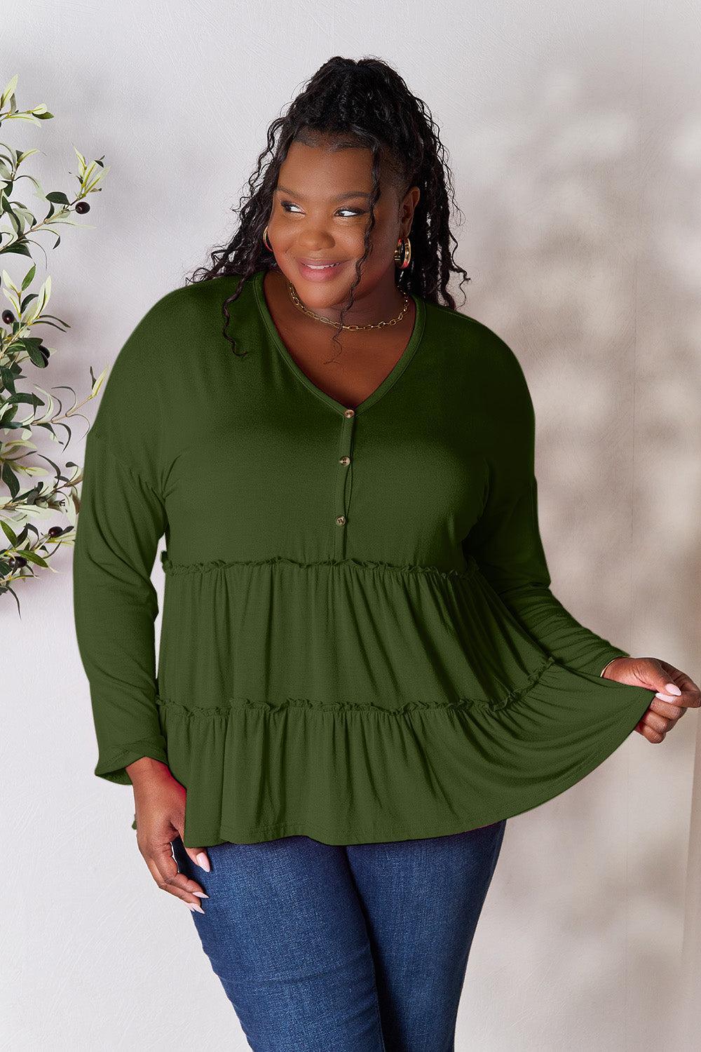 a woman in a green top posing for a picture