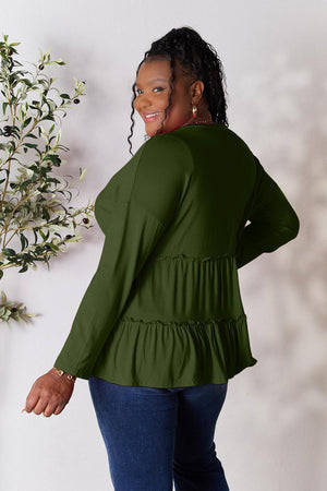 a woman standing in front of a plant