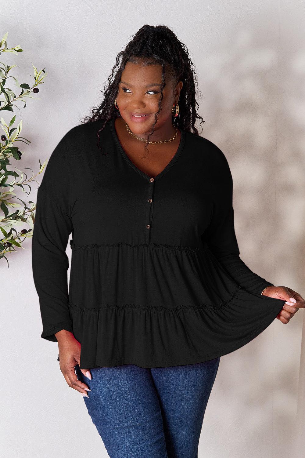 a woman in a black top is posing for a picture