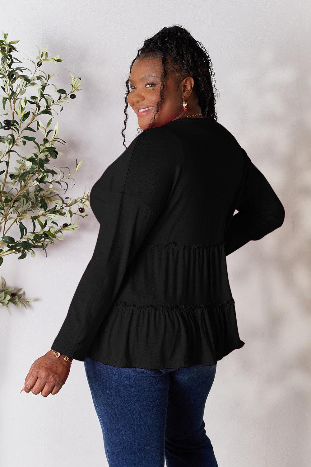a woman standing in front of a white wall