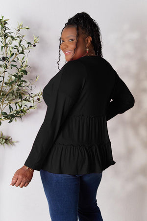 a woman standing in front of a white wall
