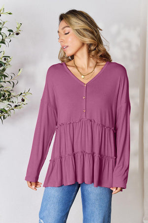 a woman wearing a purple top and jeans