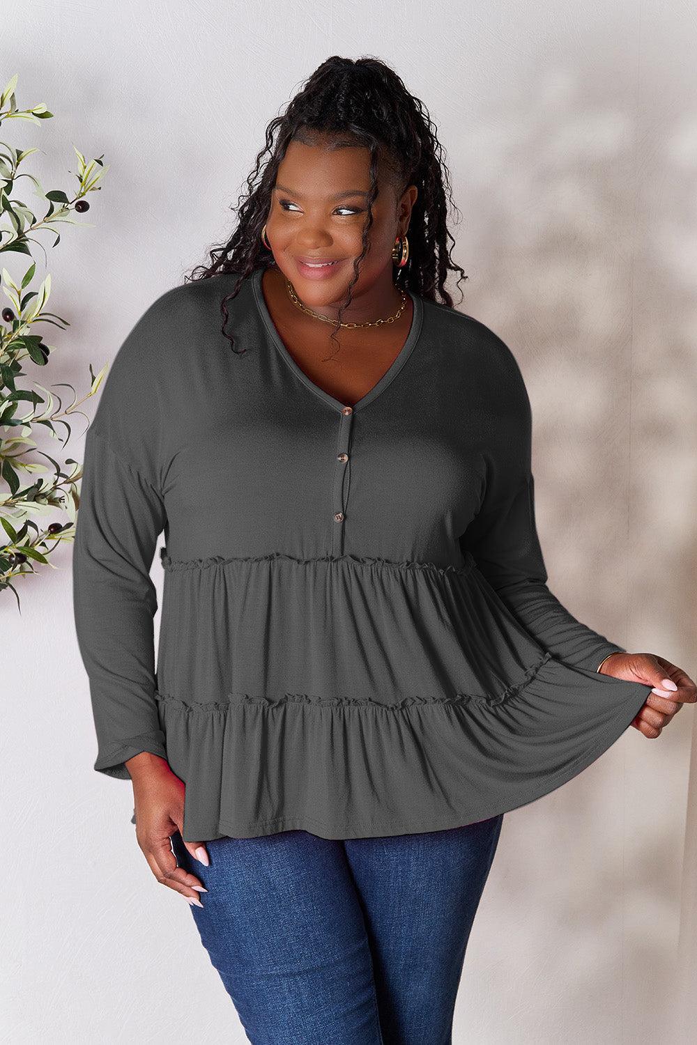 a woman standing in front of a white wall