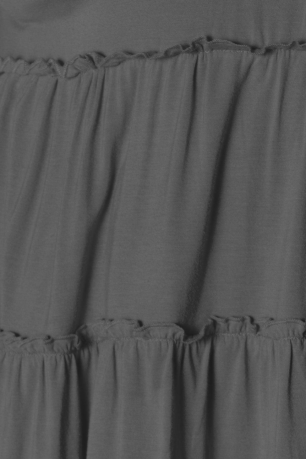 a black and white photo of a dress with ruffles