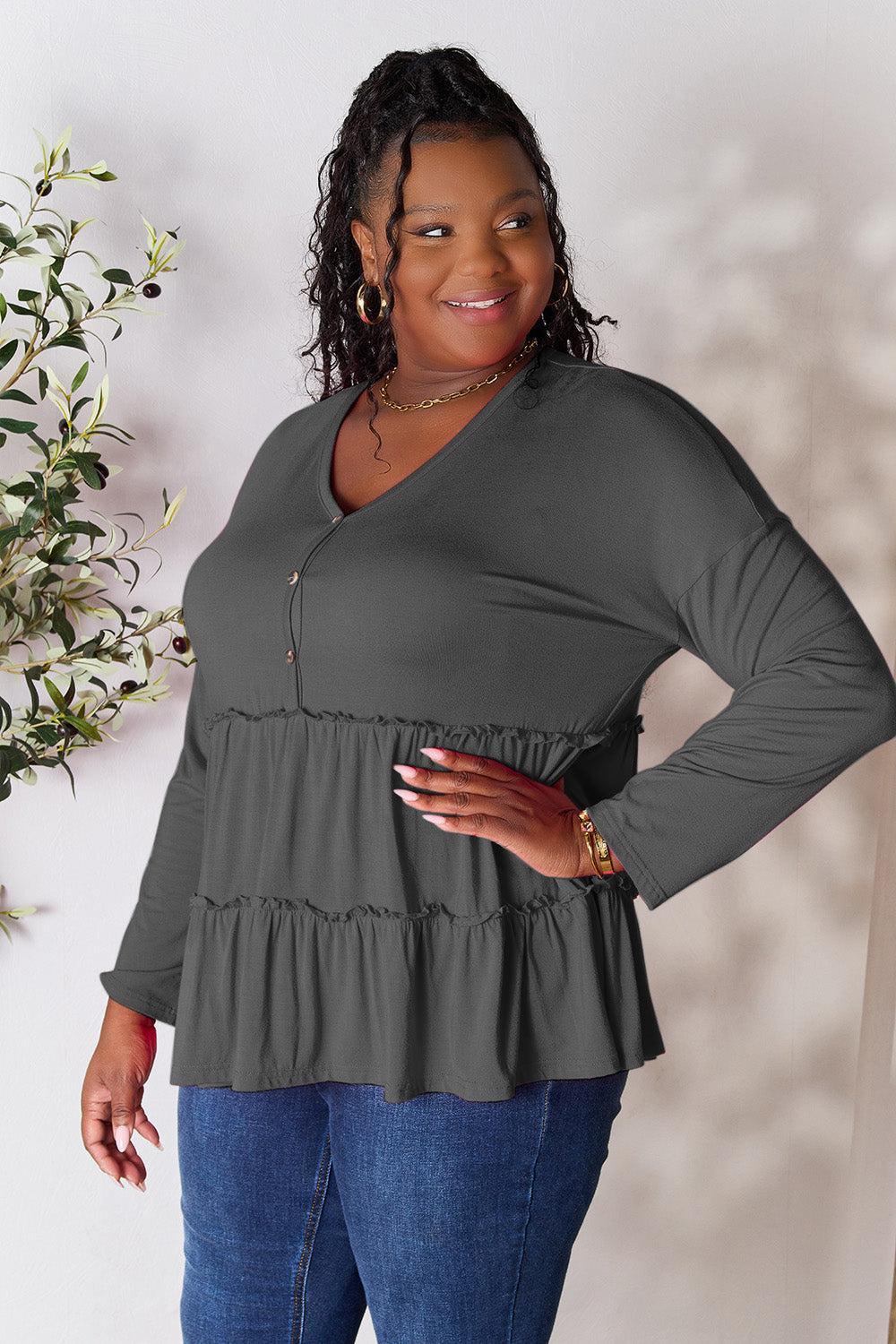 a woman standing in front of a white wall